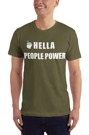 Person wearing an olive green unisex t-shirt that says “Hella People Power” in large bold font across the chest. Also shows the CDP logo, which is the silhouette of a head with the Oakland tree as a brain and a lightbulb over the head.